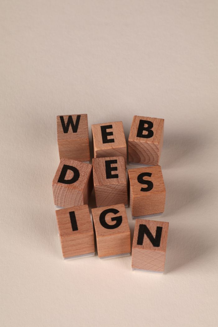 hero-img-01 Wooden blocks arranged to spell Web Design. Ideal for creative, digital content themes.